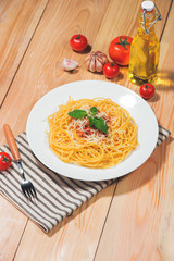 Wall Mural - Plate of tasty spaghetti with tomato sauce and meat on wooden table.