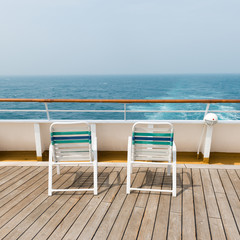 row of sun chairs  on the ship deck