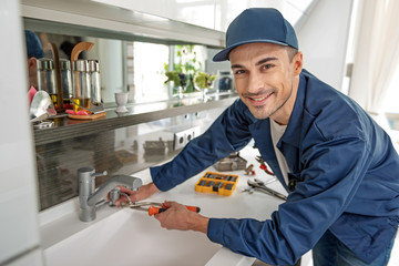 Cheerful male person using tools