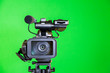 Camcorder on a green background. Filming in the interior. The chroma key.