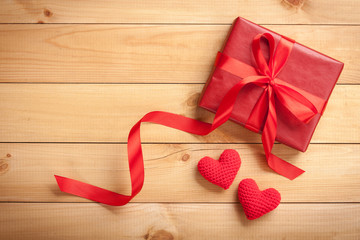 Canvas Print - Red gift box and crochet hearts on wooden background