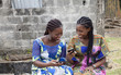 © Josiane Faubert/PICHA - Young women having fun checking phones
