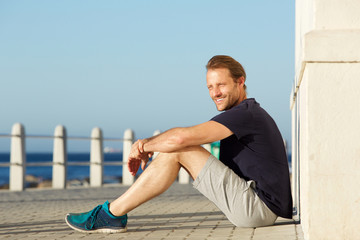 active middle age man sitting outside and smiling