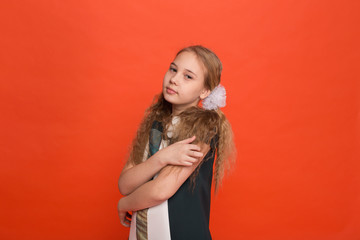 Girl in beautiful stylized dress on a red background in the studio