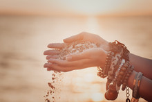 A Woman With Sand Falling Through Her Hands.summer Background