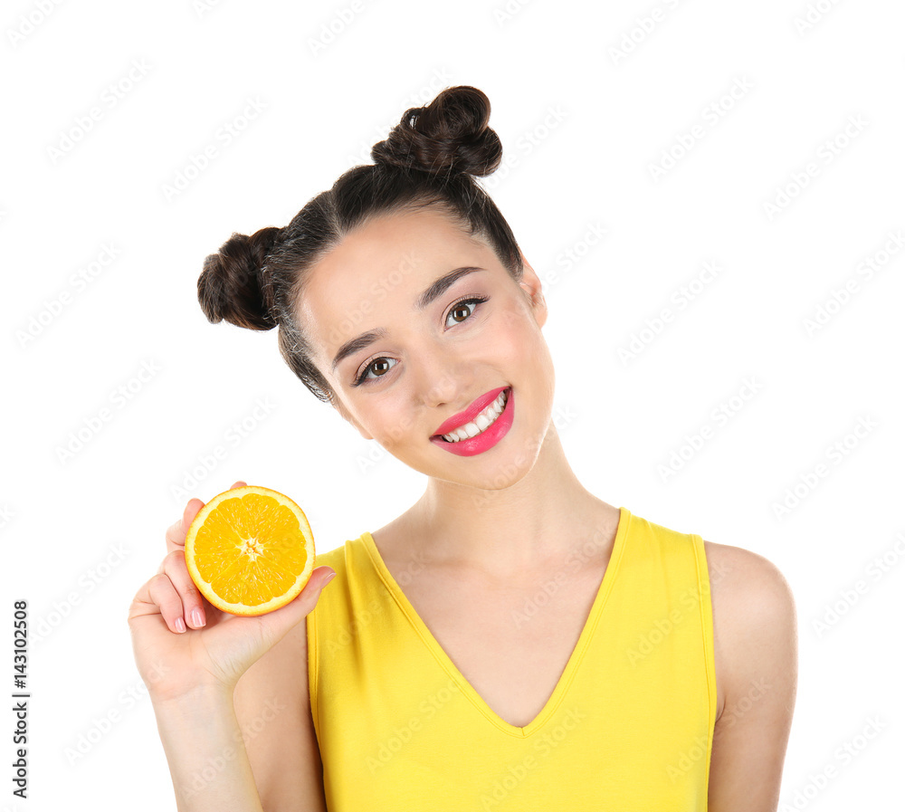 Beautiful young woman with orange on white background