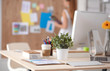 © shefkate - Young woman working in office, sitting at desk