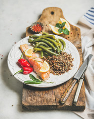 Wall Mural - Healthy protein rich dinner plate. Oven roasted salmon fillet with multicolored quinoa, chilli pepper and poached green beans on rustic wooden board over grey marble background. Clean eating food