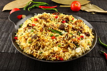 Homemade Delicious Mutton Dum Biriyani Or Pilaf Served In Cast Iron Cookware.