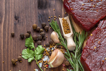 raw beef steak with ingredients for cooking