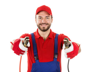 Fototapete - smiling car mechanic with jumper cables isolated on white background