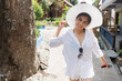 © DarKinG - asian woman wearing white shirt and white big hat and have a big smile