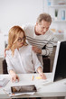 © zinkevych - Distracted manager collaborating with senior colleague in the office