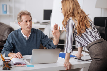 Shocked mature manager expressing indignation in the office