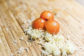 Cherry tomatoes and cheese on a cutting board