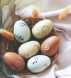 Decorative Easter Eggs in wooden Basket on Napkin