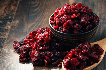 Wall Mural - Composition with bowl of dried cranberries on wooden table