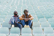 © santypan - Two black race friends having fun in the park.
