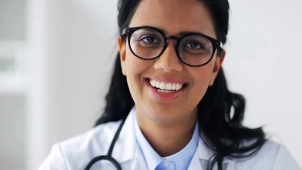 Sticker - face of happy smiling young doctor in glasses