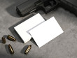 © ekostsov - White business cards on concrete floor with gun and bullets. rendering