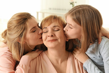 Wall Mural - Happy mature woman with her family at home