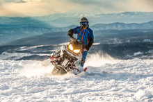 Rider On The Snowmobile In The Mountains. Active Drive