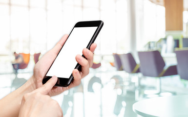 Poster - Hand click mobile phone with blur bank counter background bokeh light,White screen mock up template for adding your design or your text