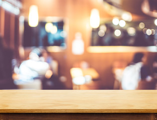 Wall Mural - Empty wooden brown table top at blur restaurant background with bokeh light, Mock up template for display or montage of product,Food Business presentation