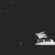 © princeoflove - back of male asian musician playing piano, black and white