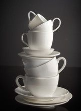 Stack Of White Coffee Cups And Plates
