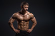 © Fotokvadrat - Handsome muscular bodybuilder posing over black background