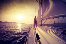 Couple On The Sailing Boat At Sunset