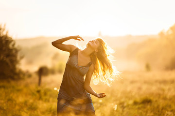 Dancing girl at sunset