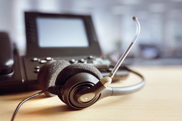 Wall Mural - Headset headphones and telephone in call center