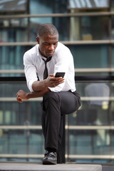 Wall Mural - young african american businessman using smart phone