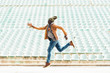 © santypan - American man jumping in the park.