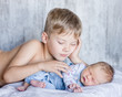 © Ermolaev Alexandr - Young boy lying with newborn sister