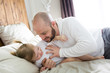 © Louis-Paul Photo - Father with adorable baby toddler on bed