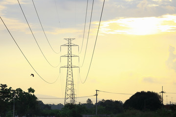 The dark tone of High voltage pole, electrical pylons, with Sun rise tone, electrical concept.