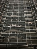 Fototapeta Kwiaty - scaffolding on whole  block of flats facade for thermal isolation and facade work construction 