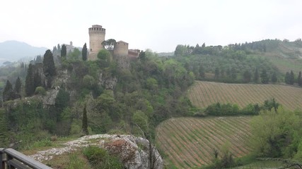 Canvas Print - tourist watching the view of Brisighella with the green valley, the fortress and the Shrine, in Emilia Romagna in Italy