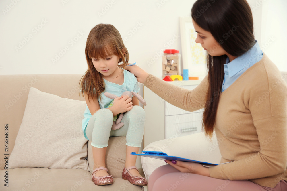 Young child psychologist working with little girl