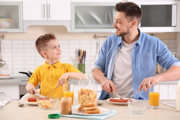 Wall Mural - Dad and son having lunch at home