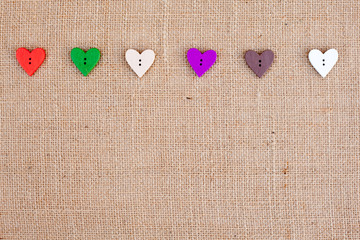 Wall Mural - background - natural color burlap hessian with heart shape buttons
