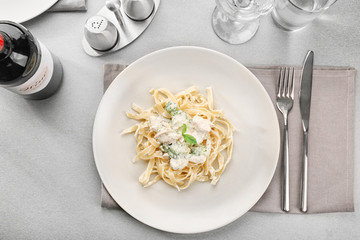 Wall Mural - Plate of delicious pasta alfredo with chicken on served table