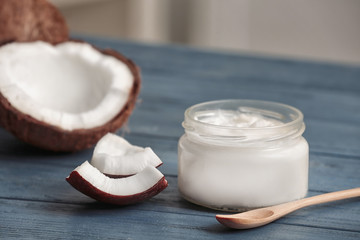 Poster - Fresh coconut oil in glassware with spoon on wooden table
