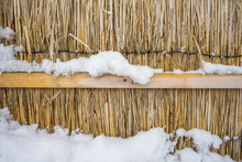 Dry Straw Wall With Snow As The Background Texture