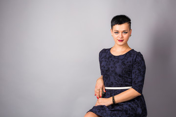 Portrait of short haired woman in blue dress