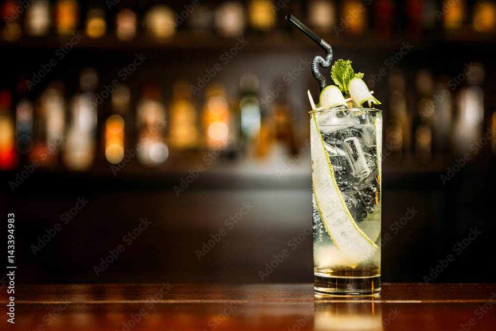 Cocktail with cucumber on a bar counter in a night club - obrazy, fototapety, plakaty 