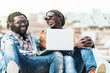 © santypan - Two black race friends having fun with laptop.